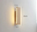 Solid wood Nordic Japanese style LED wall lamp with warm light, 32cm size, mounted above a wooden bedside table