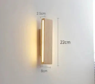 Solid wood Nordic Japanese style LED wall lamp with warm light, 32cm size, mounted above a wooden bedside table