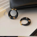 Hong Kong style retro stud earrings with dripping oil finish and rhinestone accents in black and red colours
