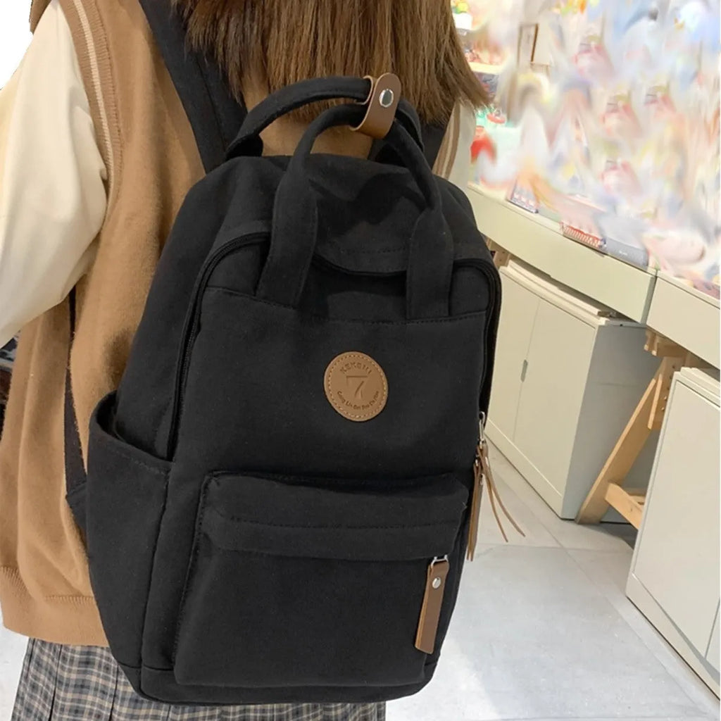 Black Oxford cloth fashion backpack with curved shoulder straps for burden reduction