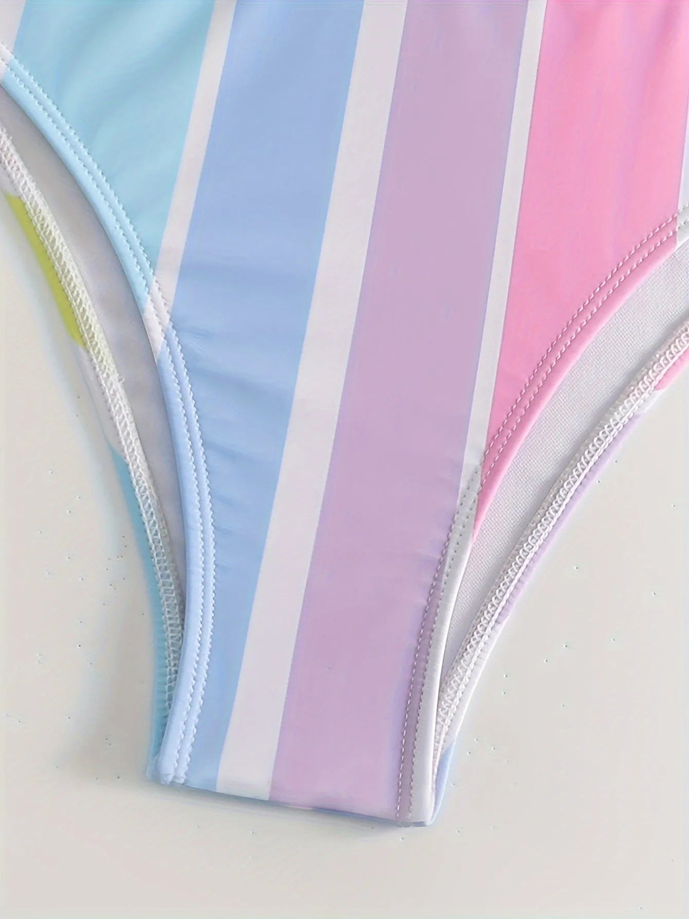 Women's striped sports bikini top and briefs on a mannequin, showing the European and American style pattern.