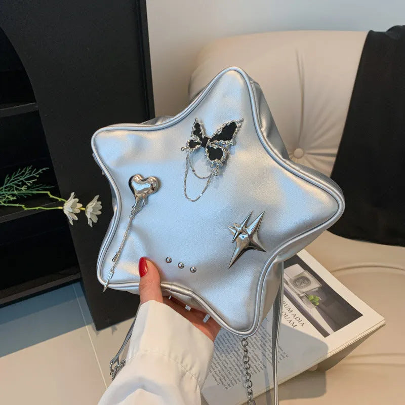 Black women's PU leather backpack with a silver metal butterfly star pendant, chain details, and an external pocket.