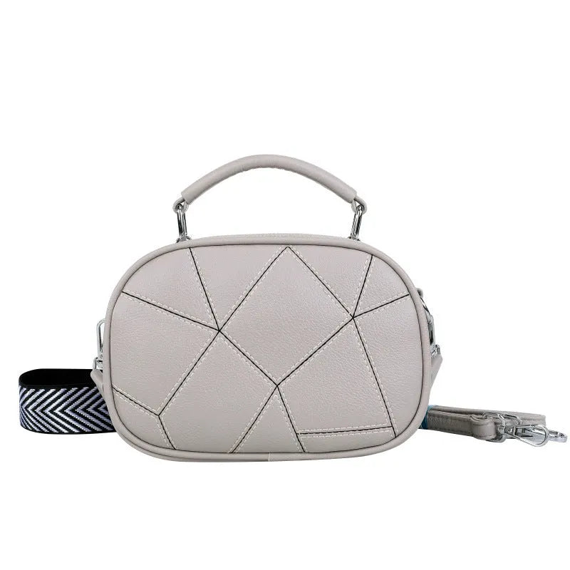 Small round patchwork bag in PU with visible stitching details, shown in beige colour