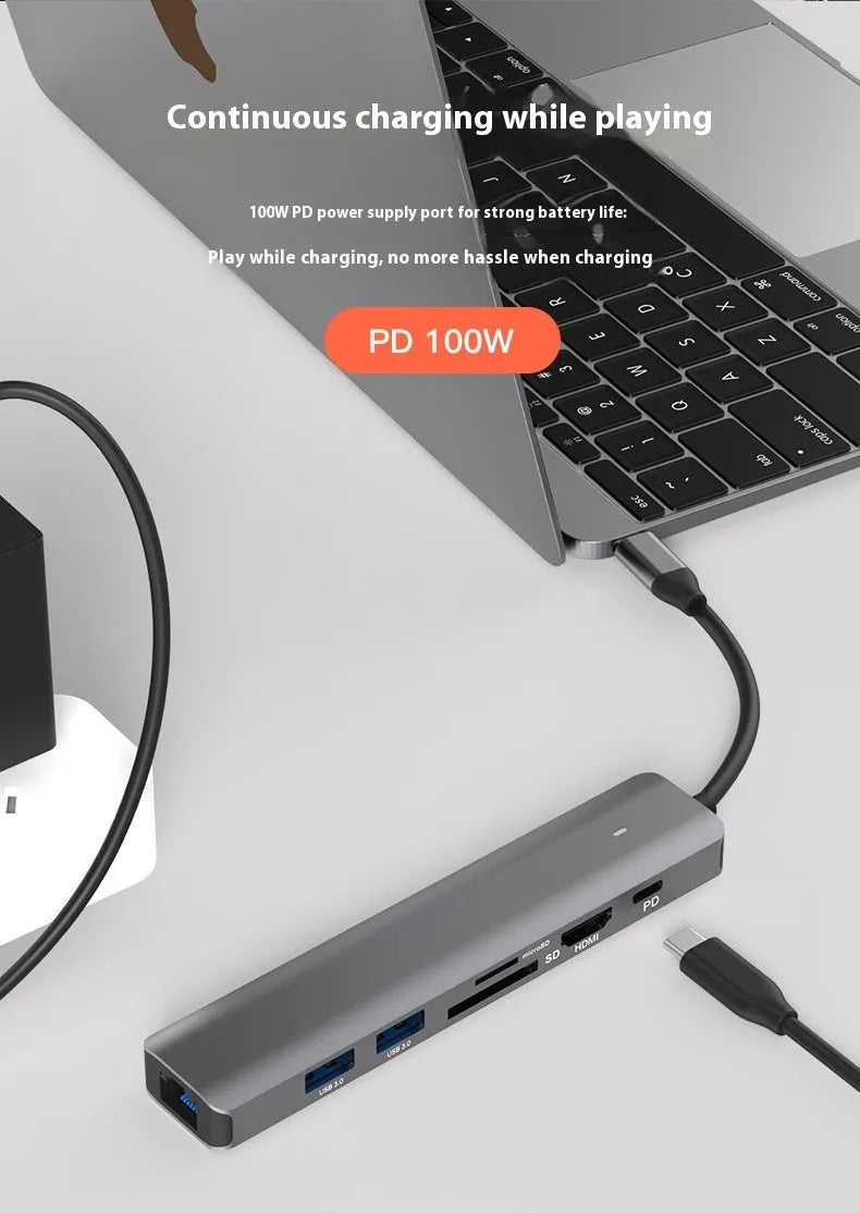LQT-LH07 7-in-1 USB-C card reader and computer hub on a desk next to a laptop.