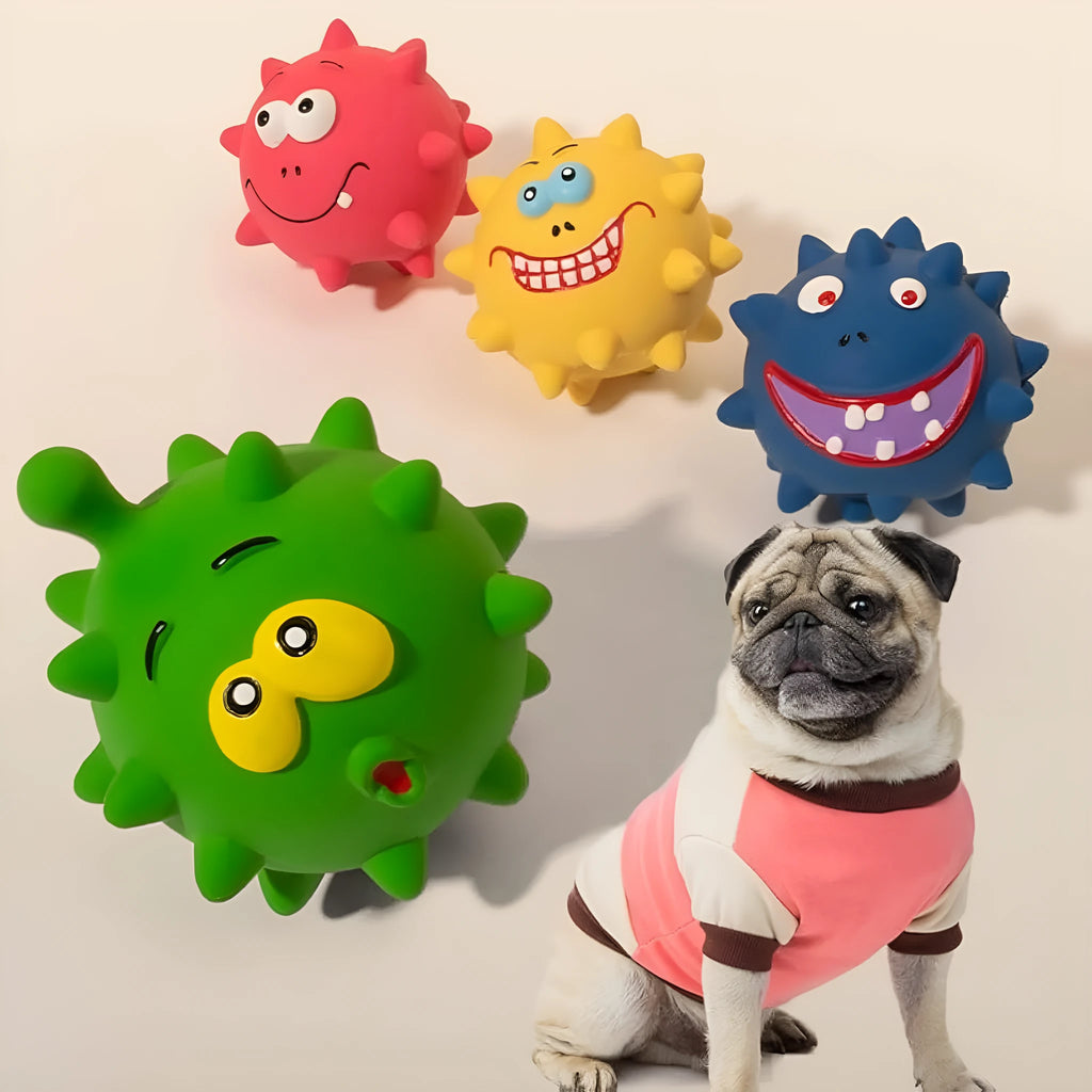 Set of four colourful latex squeaky dog balls with cute faces, shown next to a dog.