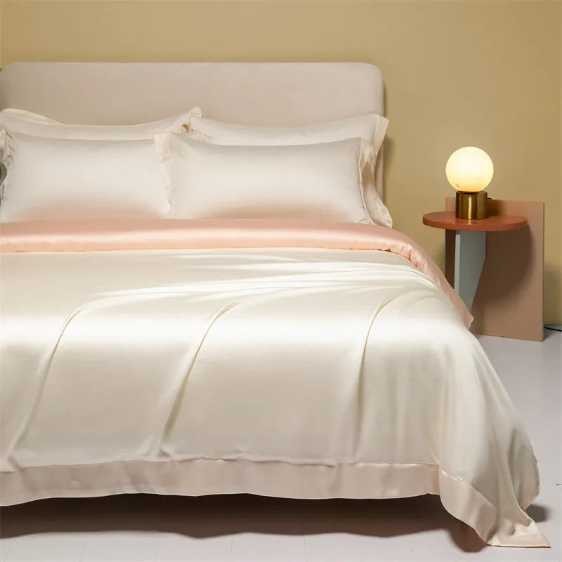 Luxury Lenzing Tencel quilt cover and pillowcases in Aurora Blue on a bed, showing satin weave texture.