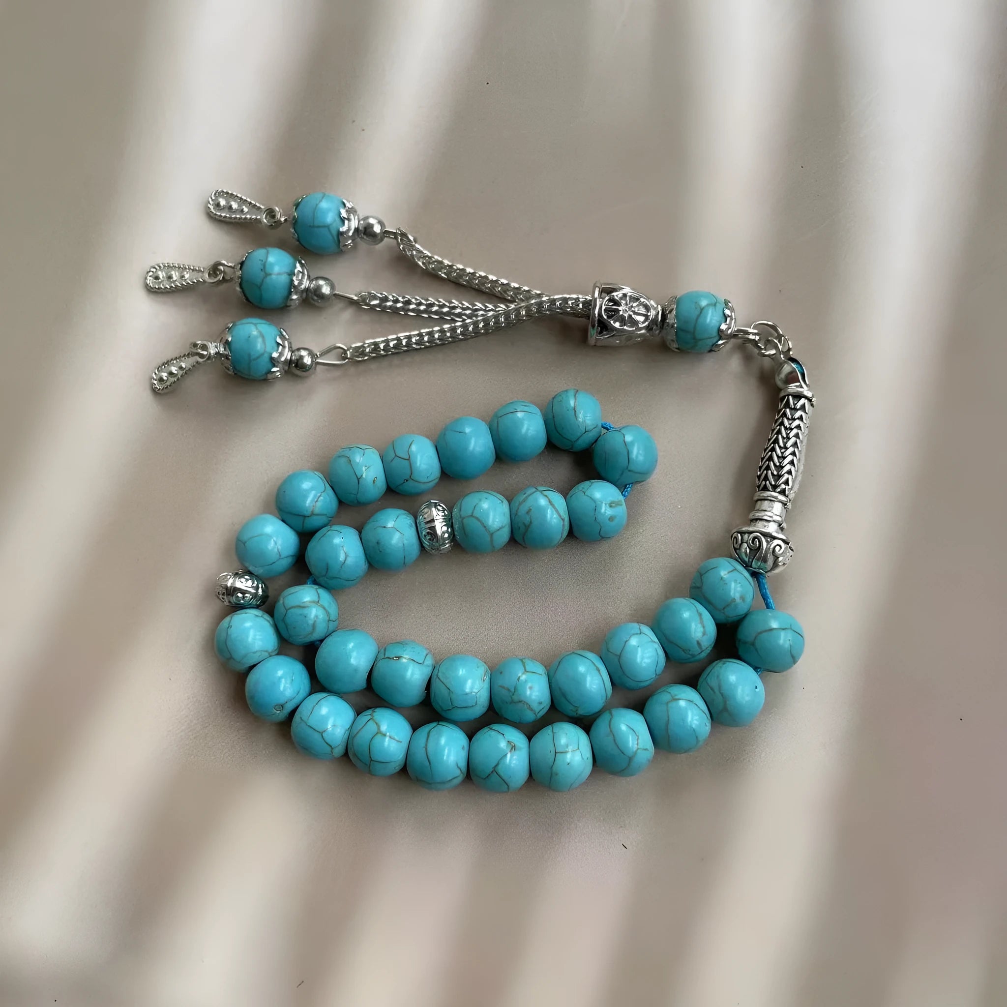 Handmade Muslim prayer bracelet made of sky blue 8mm stone beads on a wrist.