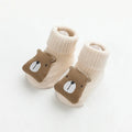 Pair of light grey baby socks with white non-slip silicone grip dots on the soles.