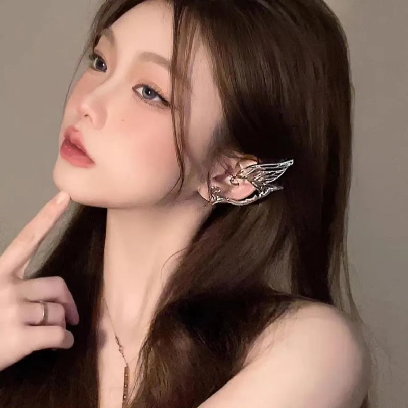 Butterfly wing ear clip made of alloy with electroplated finish, geometric textured design, available for left or right ear.