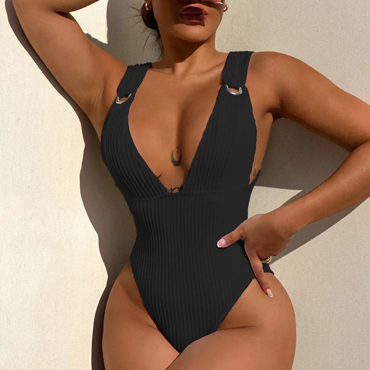 Women's solid colour one-piece swimsuit in black, white, green, or orange.