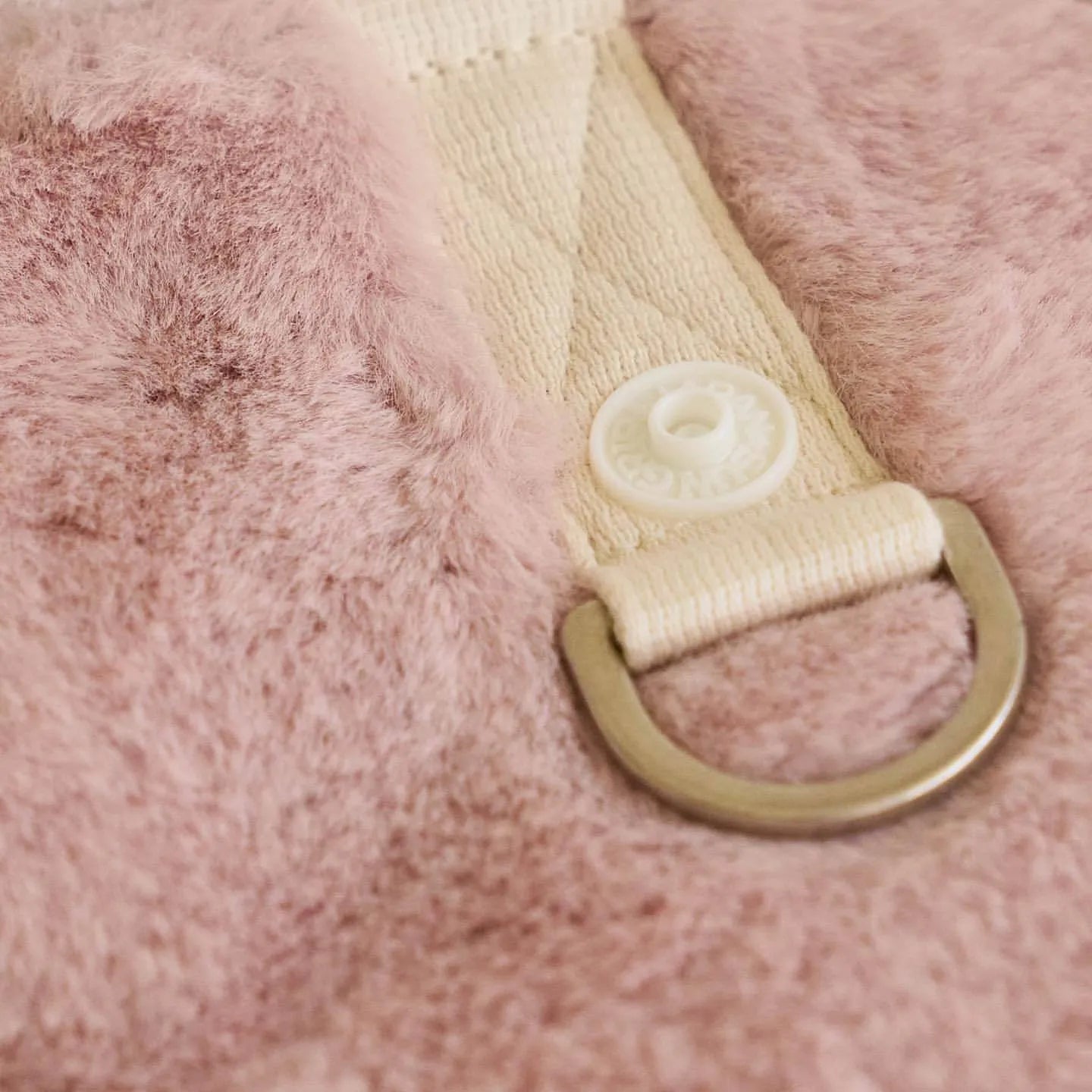 Light pink polyester dog coat shown on a pet, with casual styling and size tags for XS to XL.