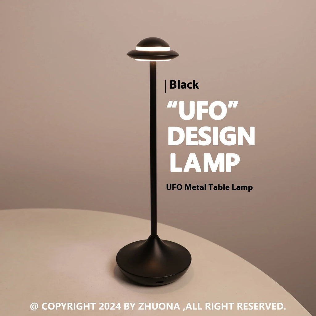 Modern UFO-shaped table lamp in grey with a circular shade on a weighted base, showing touch controls.