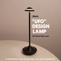Modern UFO-shaped table lamp in grey with a circular shade on a weighted base, showing touch controls.