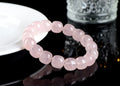 Pink crystal barrel bead bracelet with geometric beads on an elastic cord