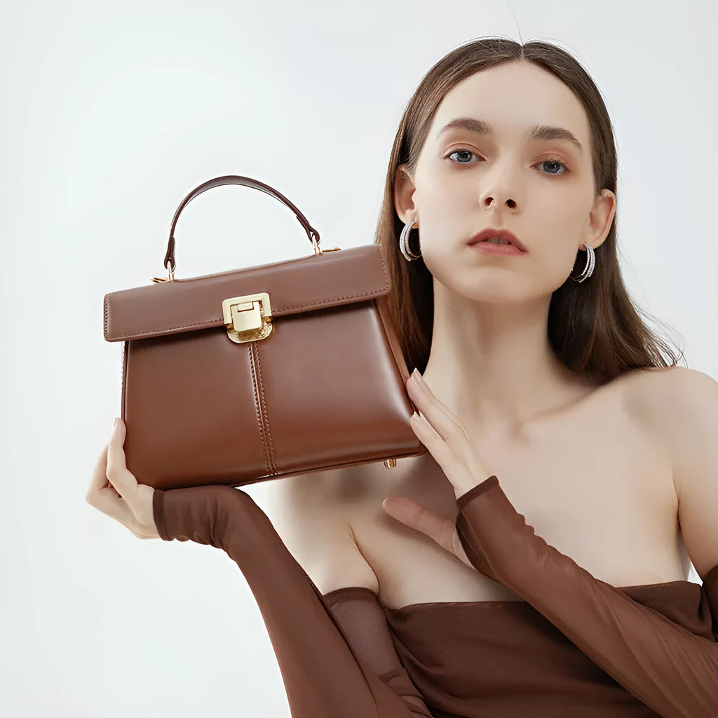 Black genuine leather women's shoulder bag with a front clasp, shown with a detailed view of the internal zip pocket.