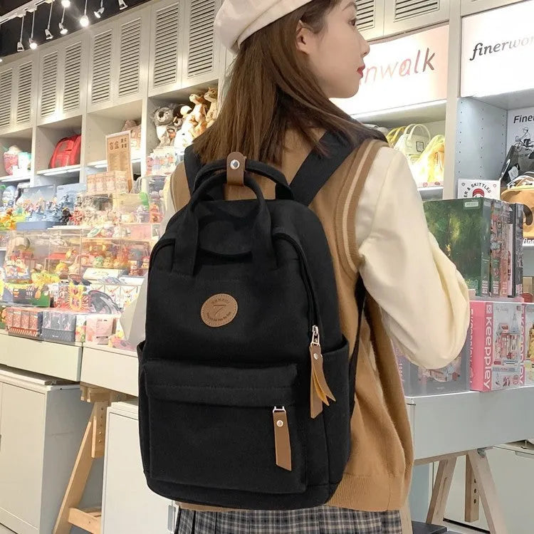 Black Oxford cloth fashion backpack with curved shoulder straps for burden reduction