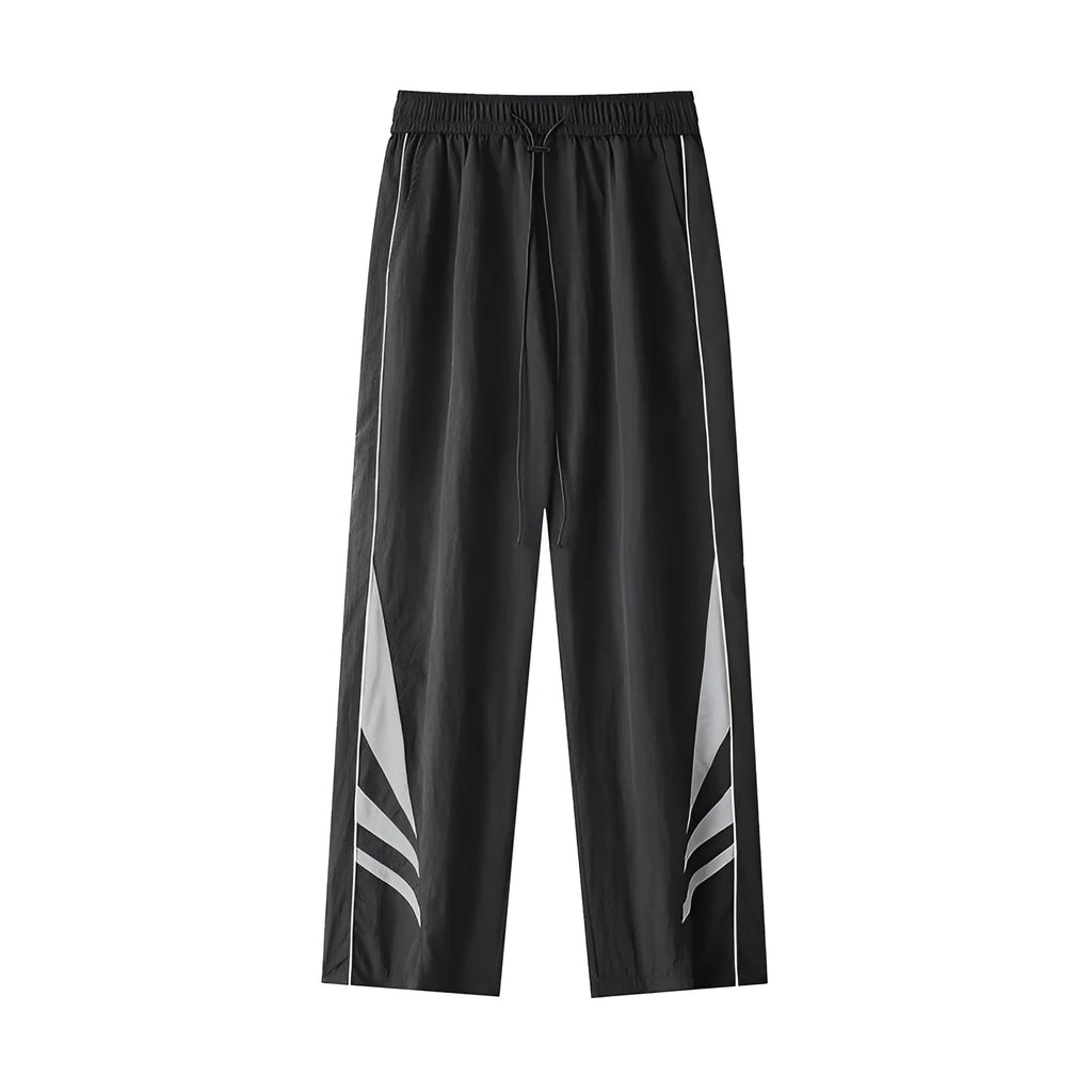 Men's straight-leg casual trousers in black, showing loose fit and button fly detail.