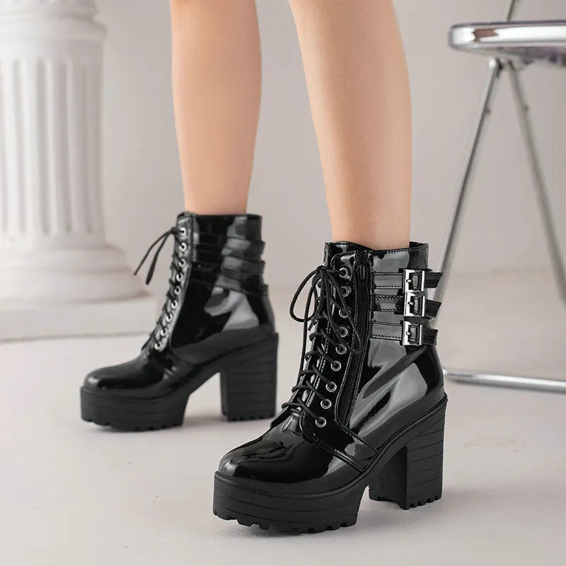 Women's black thick-heeled ankle boots with a lace-up front and waterproof platform on a rubber sole.