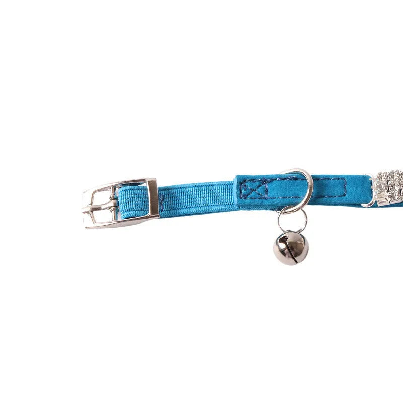 Soft pink flocked cat collar with a plastic buckle on a 28cm elastic band, showing gang drill holes for tags.