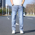 Tapered fit stretch denim trousers for business casual wear in light blue, grey, blue-grey, or black.