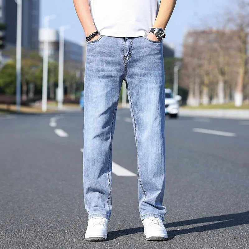 Tapered fit stretch denim trousers for business casual wear in light blue, grey, blue-grey, or black.