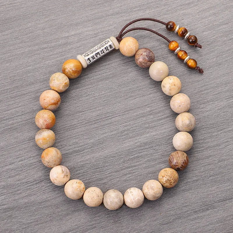Handmade wood colour stone bead bracelet with adjustable closure on wooden background