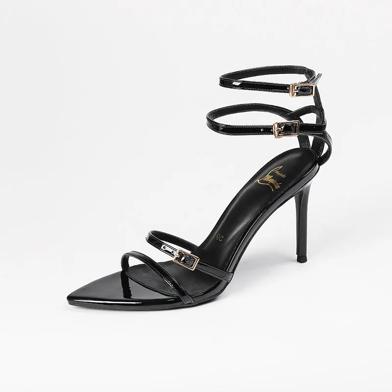 Black patent leather women's ankle strap stiletto sandals with an 8cm heel and open toe.