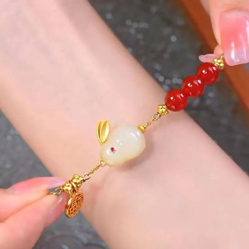 Green electroplated jade hare bracelet for women with Chinese style and lily design elements.