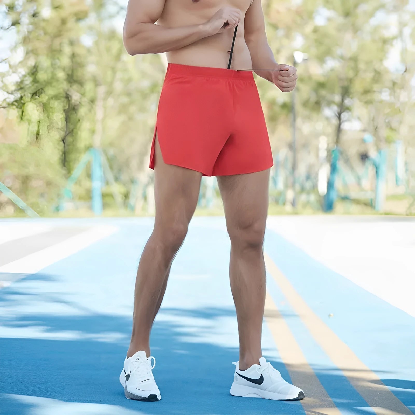 Man wearing high-waisted grey off-road running shorts, showing loose fit and athletic design.