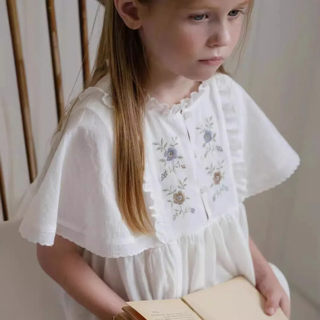 White cotton girls dress with embroidered ruffles, short sleeves, solid colour A-line shape