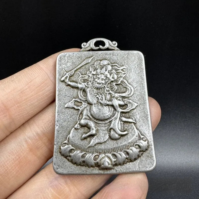 Close-up of a Chinese geometric style cast iron pendant ornament with an antique finish.