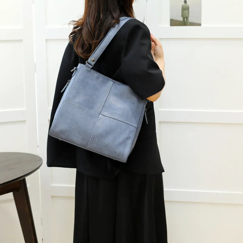 Soft PU leather crossbody handbag with barrel shape and vintage styling in light khaki colour
