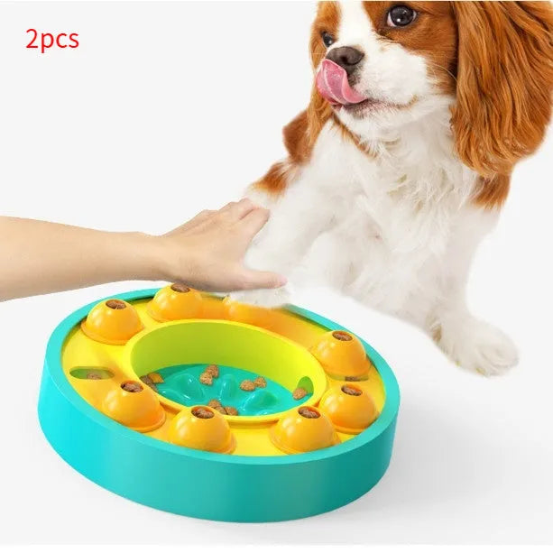Square green dog puzzle toy with a central feeding well and a rotating turntable lid on a hard floor.