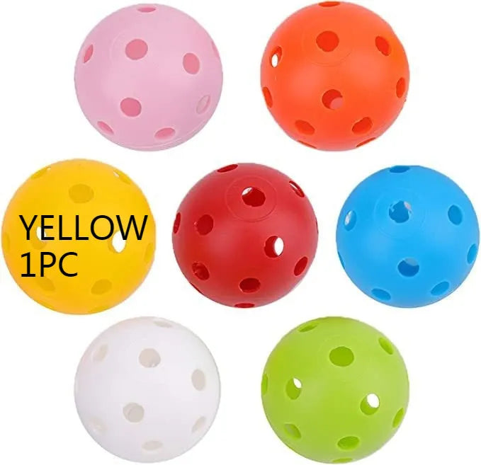 Multi-colour golf practice balls with 26-hole design next to a net storage bag