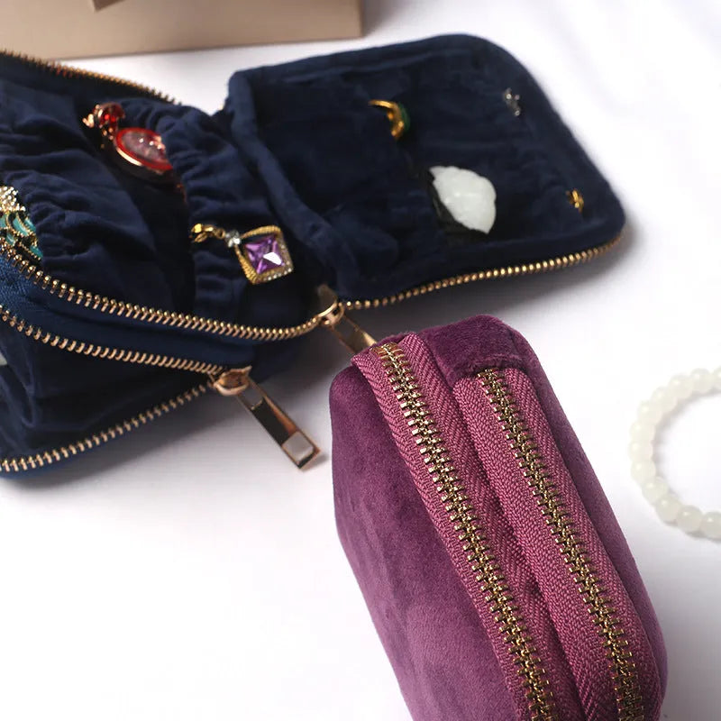 Blue PU zippered jewellery storage bag in handbag shape, 11x11x3.5cm, on a travel background