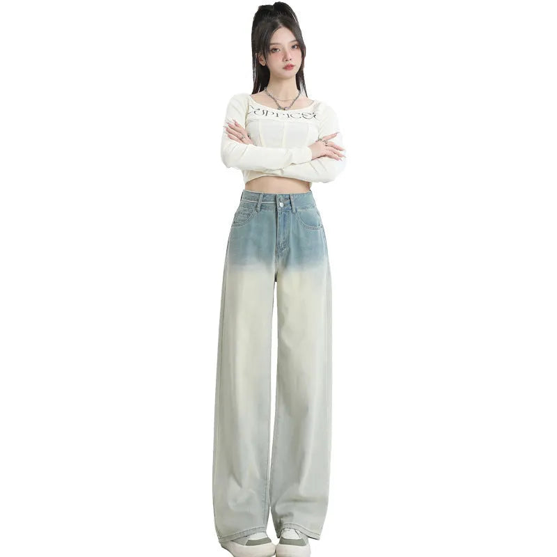 Women's gradient blue straight-leg denim trousers on a hanger.