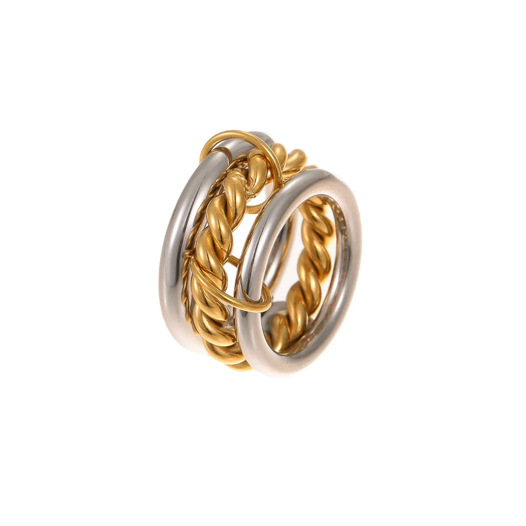 Stacked stainless steel rings with 18K gold plating in an exaggerated silhouette design.