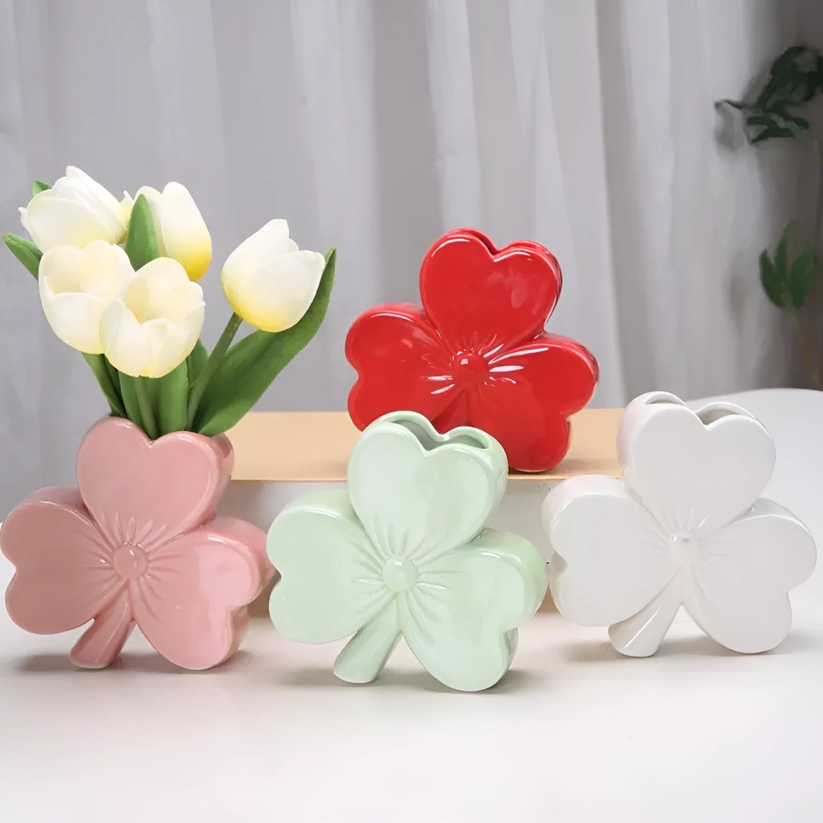 Clover white porcelain ceramic vase in European style on a desk.