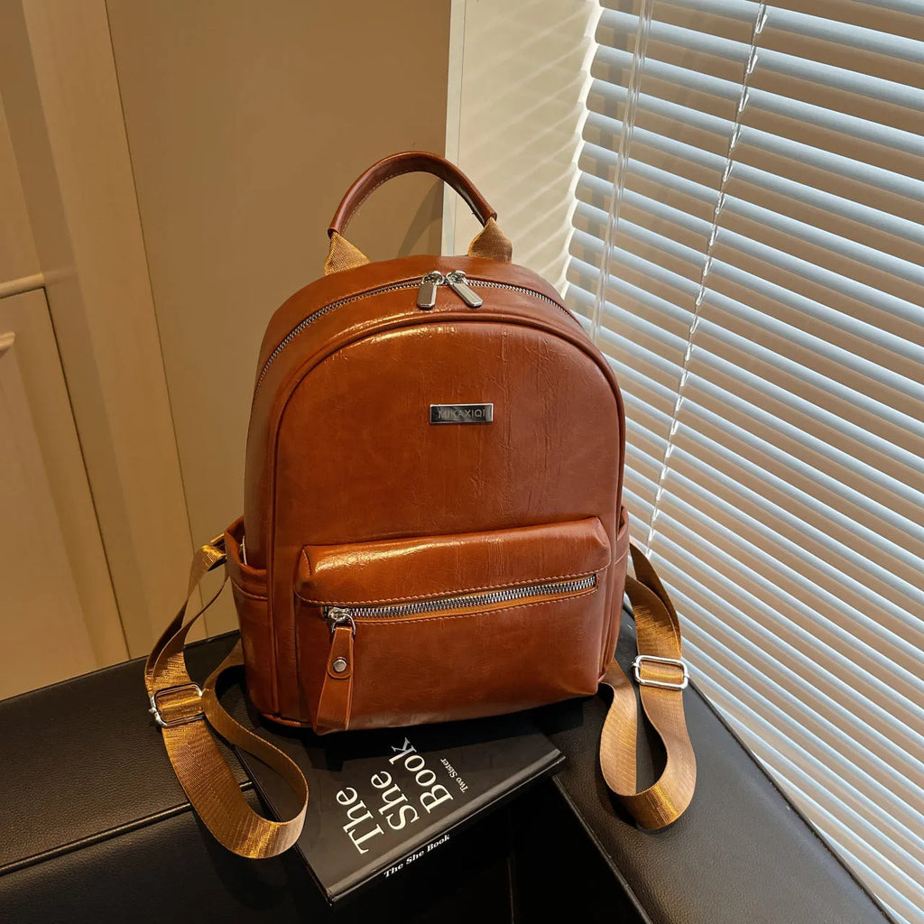 Simple fashion trendy ladies travel backpack in waterproof PU with sandwich pocket, available in multiple colours