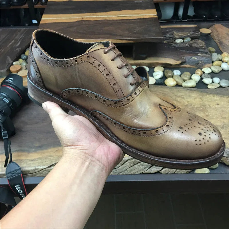 Light brown men's vintage casual leather shoes with hand-carved distressed detailing and a round toe.