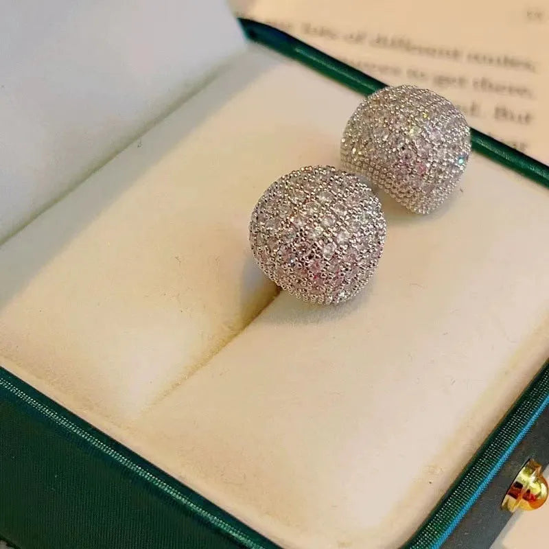 Women's drop-shaped clip earrings with full diamond elements and golden beans detailing