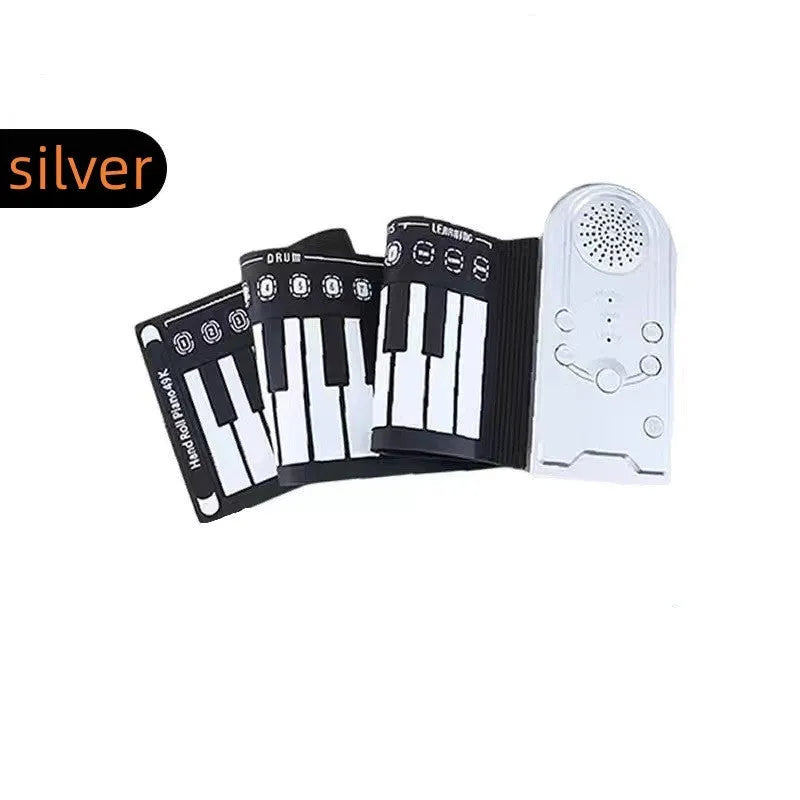Pearlescent white portable electronic keyboard with 49 silicone keys, rolled up next to its compact ABS plastic control unit.