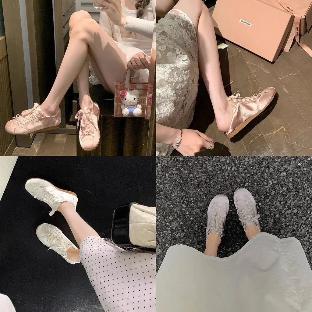 Women's champagne pink satin ballet flats with front lace-up and round toe on a white background.