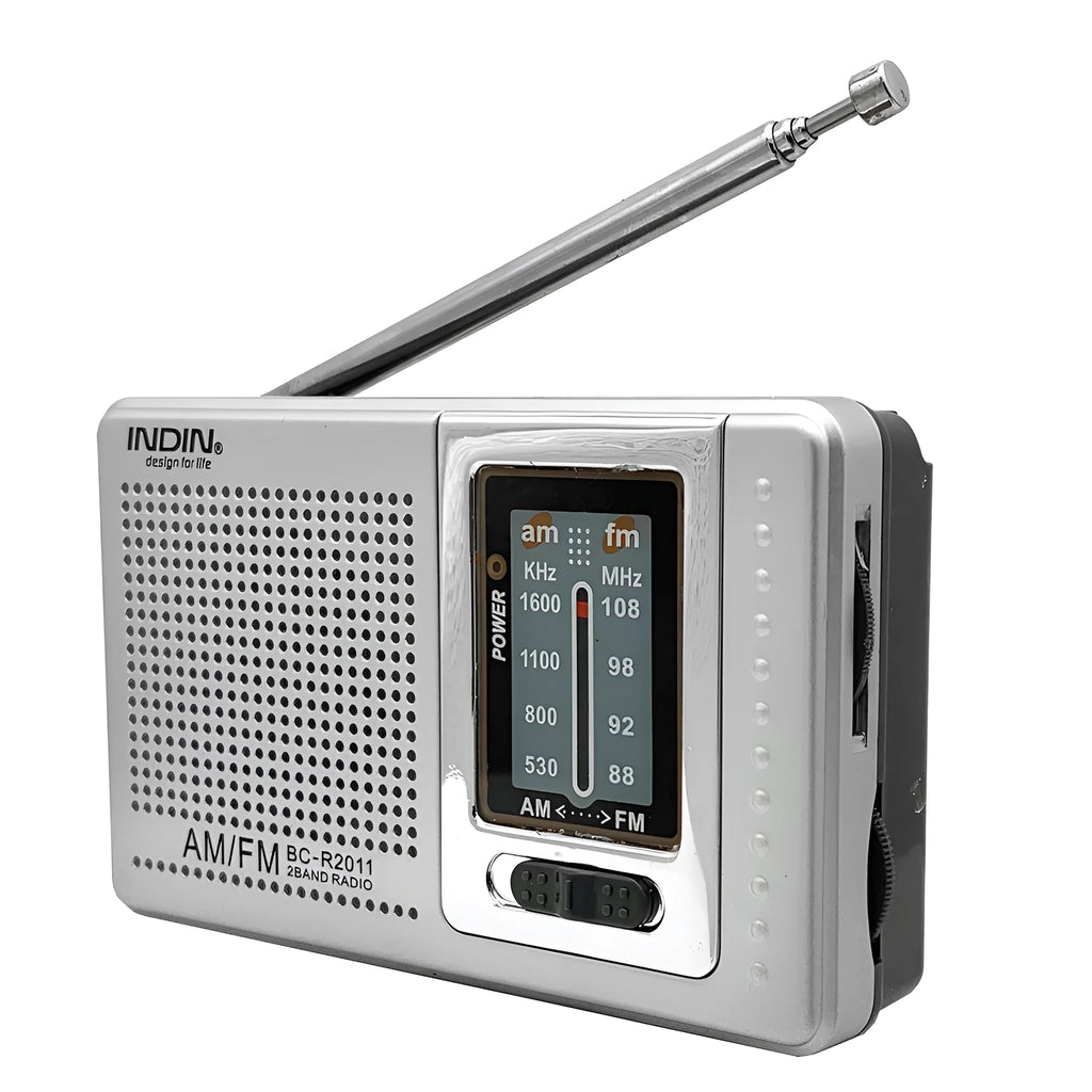 Portable silver grey FM AM radio on table, compact ABS body with built-in speaker and dial controls