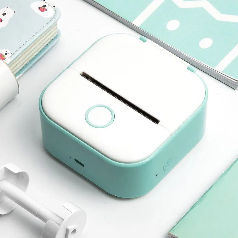 Phomemo T02 series portable mini thermal label printer in white and pink, with Bluetooth and USB charging