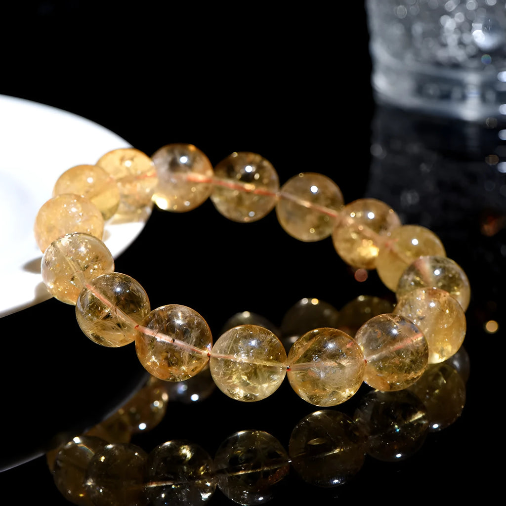 Natural yellow citrine gemstone bead bracelet on a wrist, showing geometric beads.