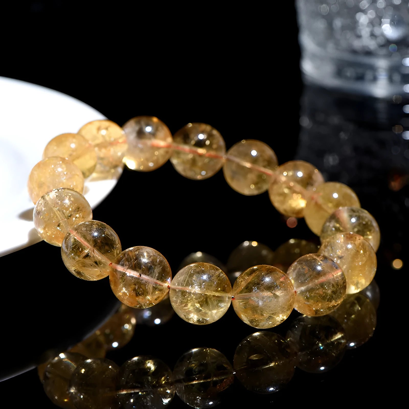 Natural yellow citrine gemstone bead bracelet on a wrist, showing geometric beads.