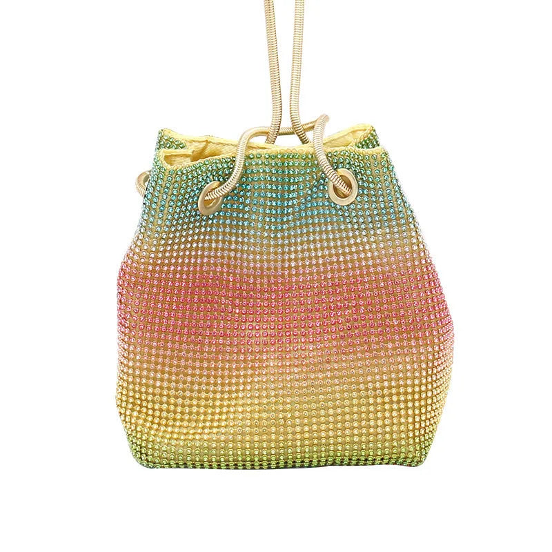 Soft rainbow rhinestone bucket handbag with adjustable strap on a white background.