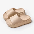 Women's beige fish mouth slippers with a thick 5.5cm EVA sole on a tiled floor.