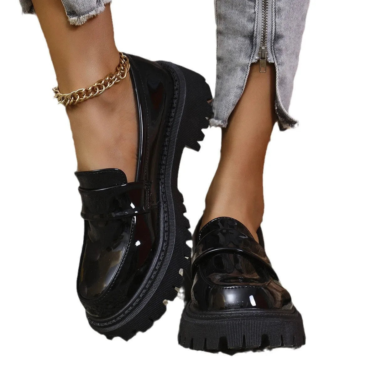 Women's black slip-on loafers with a chunky platform heel and mid-top ankle cut.